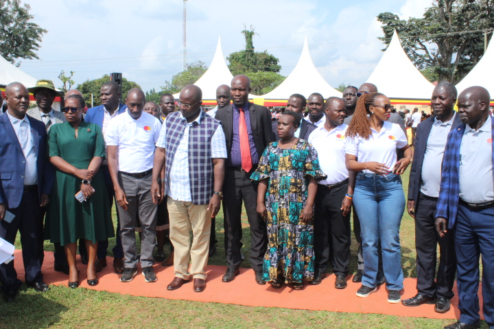 Minister Kyakulaga and Country Director Heifer International William Matovu (in the middle) pose with local leaders and Heifer International staff